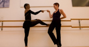 Elvia and Bayan dance together in a dance studio.