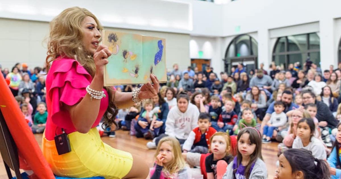 Bella Aldama reads to a crowd of children and adults