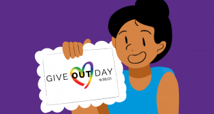 Person holding Give OUT Day paper