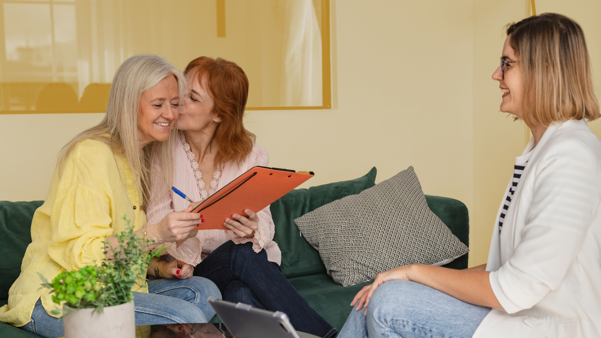 Lesbian couple sit with their professional advisor.